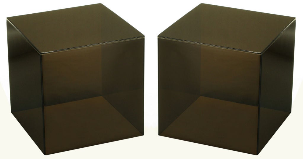 Pair of dark smoked Lucite cube tables. Wonderfully square and recently polished, can be used as a split coffee table or unexpected end tables.