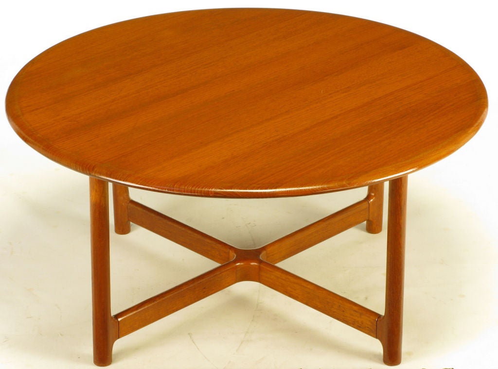 Solid teak wood coffee table manufactured by Norwegian cabinet maker, Rasmus Solberg. Bull nose edge top, dowel style legs with a low carved X stretcher.