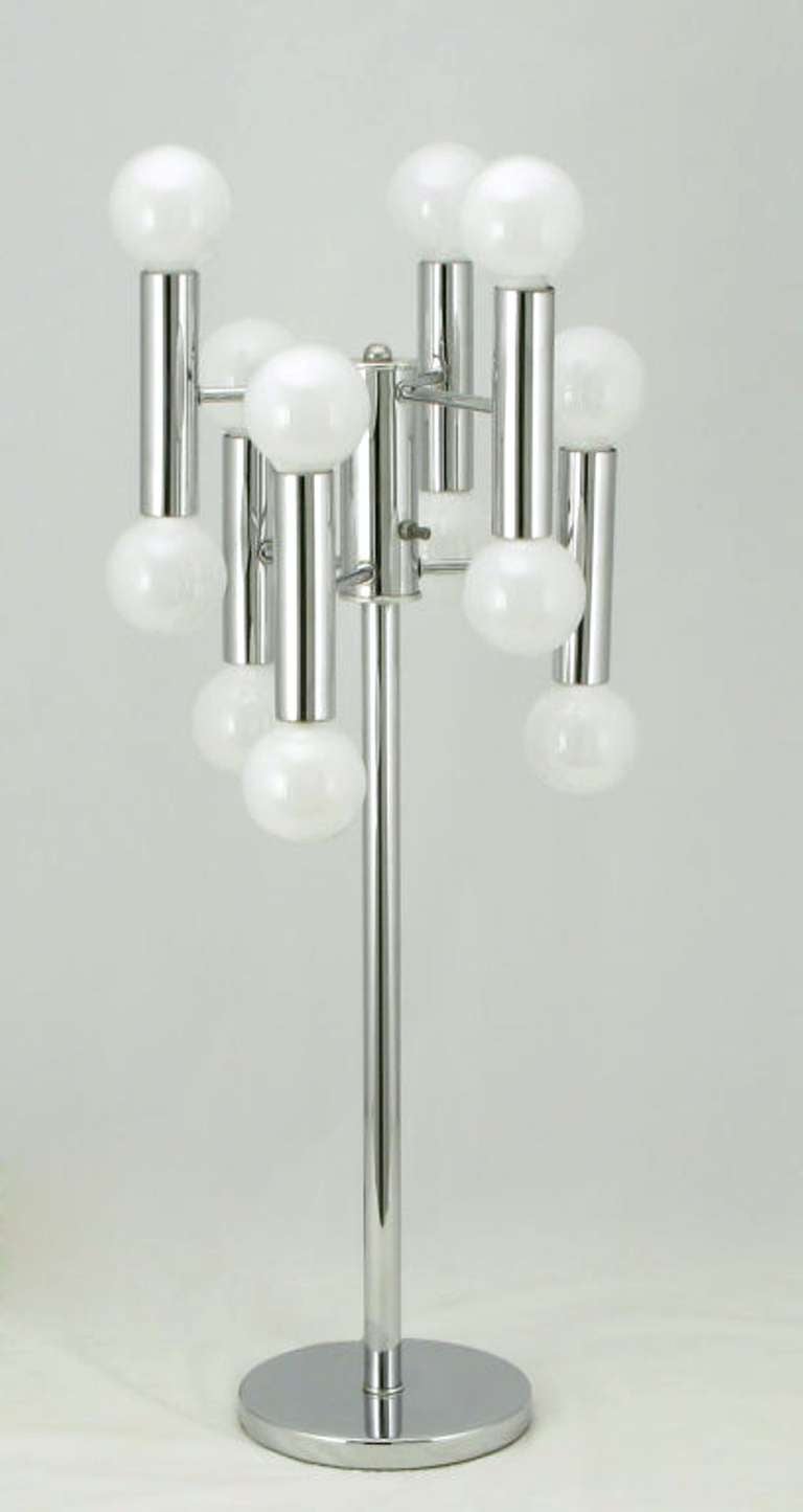 Chrome six arm, twelve light, modern table lamp in the manner of Robert Sonneman designed table lamps. Six chrome cylinders are connected to the chromed center rod, with upper and lower sockets.