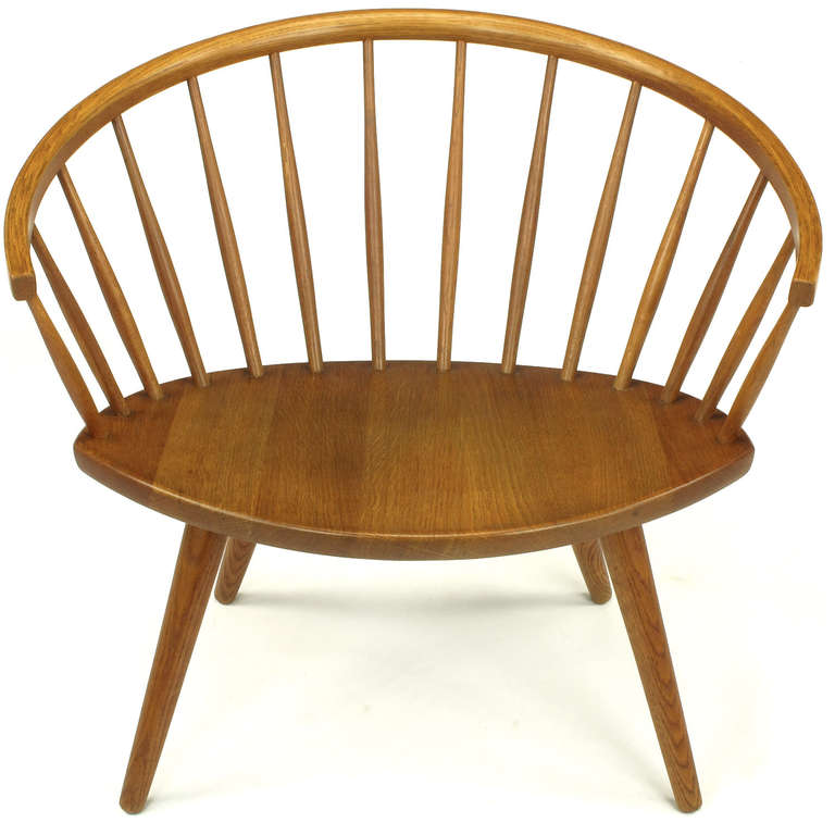 Had Nanna Ditzel designed a Windsor chair, it would likely have looked like this. Rounded back, elliptical seat, and conical legs create an unusual, yet classic, look.