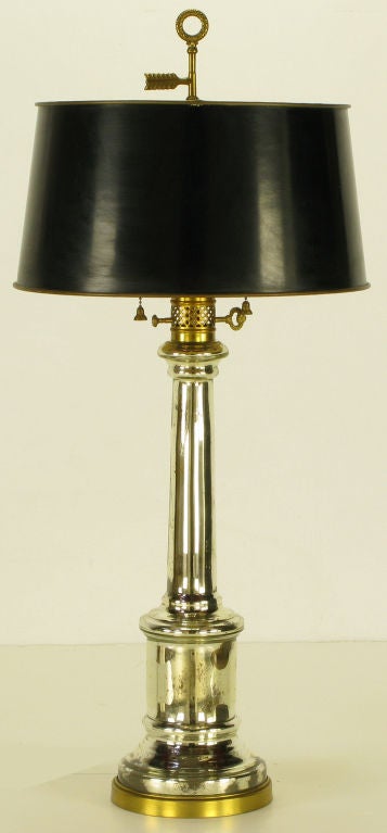 Beautifully patinated mercury glass bodied Empire style table lamp by Warren Kessler of New York. Brass base with vented brass segment and key intended to look like a kerosene mechanism. Brass stem, double socket cluster with feathered arrow and