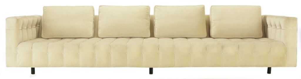 Outstanding Harvey Probber attr. button tufted even arm sofa measuring one hundred and twenty one inches long. Four loose back cushions, tuxedo style frame. Six ebonized mahogany round dowel legs are set back to lend the impression that the sofa is