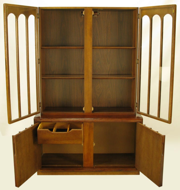Before financial strife forced its merger into Keller Williams Furniture, Keller Furniture was the dream of a Tulsa, OK designer.  An example of Keller's early work is this tall cabinet, with glass and walnut wood colonnade doors for the illuminated