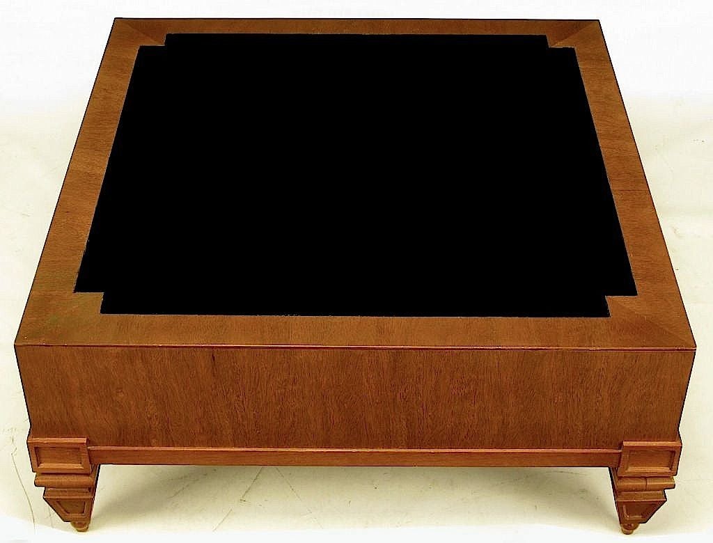 Unexpected and rare Tomlison transitional square bleached mahogany coffee table with black leather inlaid top. Clean lined with chunky empire influenced solid mahogany inverted obelisk legs with ball feet.