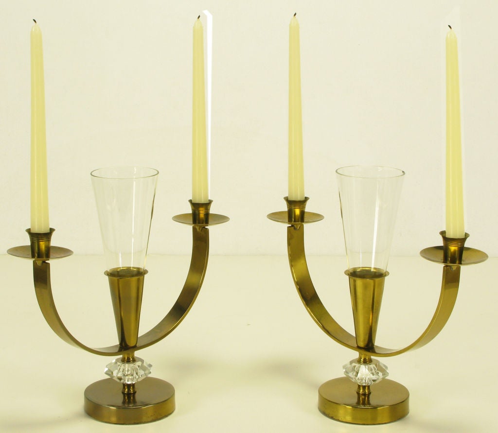 Pair of patinated brass double arm candelabra with cut crystal spacers and leaded crystal fluted center petite vase. Bobeche and striated candle cups are evocative of Tommi Parzinger desings for Dorlyn,