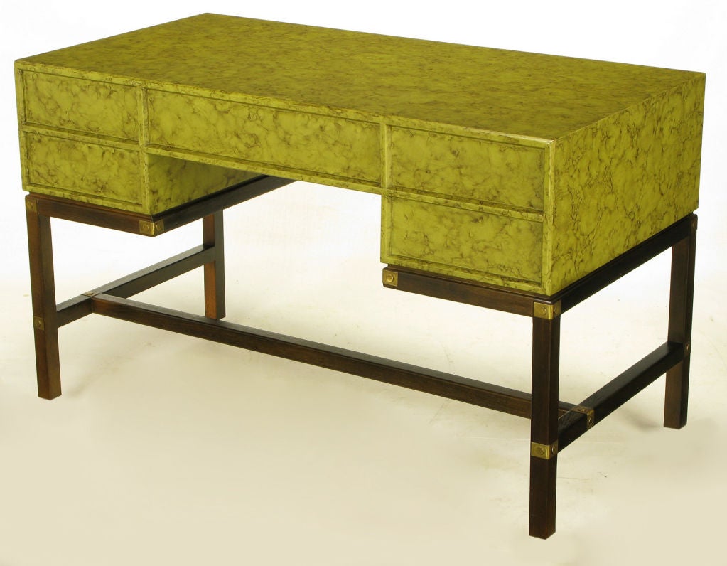Henredon olive green oil drop lacquer and dark mahogany campaign-style desk. Top casing has five drawers with drop ring pulls, with inlaid brushed brass escutcheons.  It is finished on all sides with the back having inlaid panels that mirror the