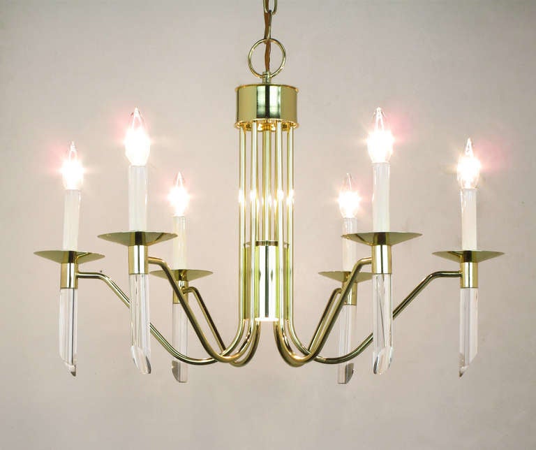 Six arm, brass and lucite chandelier by Forecast Lighting circa 1980s. Inverted spider-like arms with thin bobeches and angle cut lucite rods. Center downlight as seen in image 6. Total drop with chain and canopy is 40