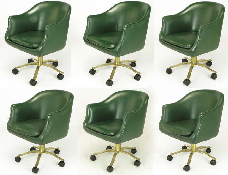 Set of six Nicos Zographos CH2 bucket chairs with fixed seat cushions clad in British racing green leather. Uncommon brushed bronze five-leg base is height adjustable and can be set to a fixed, non-swiveling position. Black lacquer casters with full