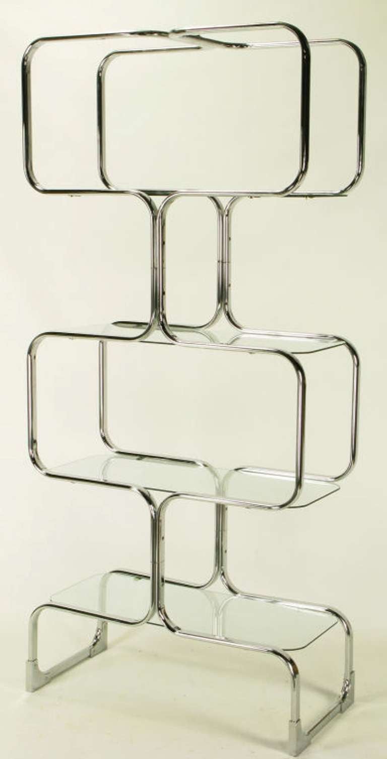 Italian chrome and glass etagere constructed of bent metal sections, with glass shelves with radiused corners. Manufactured by Italian furniture company Tricom.