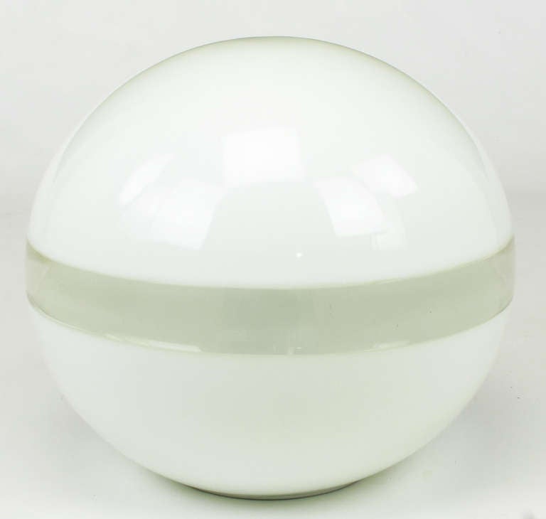 Heavy fused milk glass and clear magnified glass globe with single internal socket. Probably Italian in origin, this uncommon table/accent lamp came from the Merchandise Mart office of one of Vladimir Kagan's earliest Chicago reps.