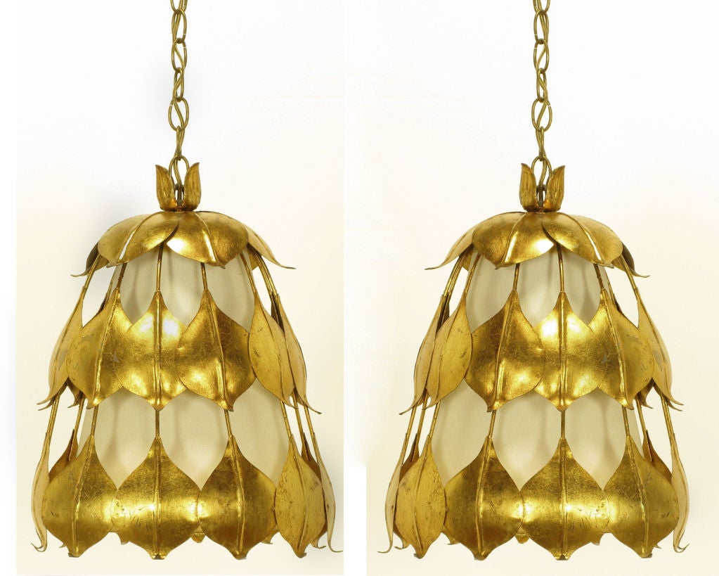 Unusual and rare gilt tole metal lotus flower petals connected in vertical sequence creating the frame of the pendant. Mounted on the inside is translucent white shade. Single socket illumination, sold with chain and canopies.