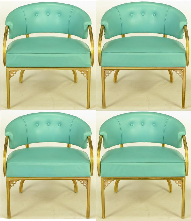 Very elegant set of four brass frame and turquoise vinyl upholstered American deco barrel back lounge chairs.  By the Troy Sunshade Company, and attributed to John Van Koert. Scrolled and scalloped square bar brass frame has white glazing.  Front