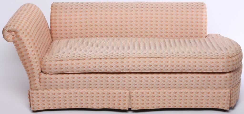 A twentieth-century interpretation of Madame Recamier's sofa or chaise, with rounded end. Roll-form arm and back are independently mounted to the base.<br />
Can be re-upholstered with or with out the skirt as the legs are clean lined tapered