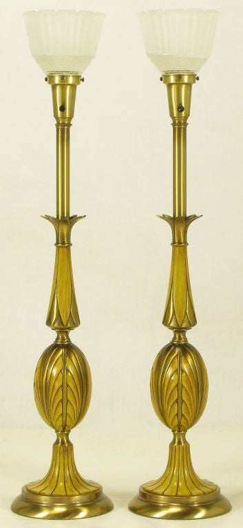 Pair of art deco inspired brass table lamps with segments lacquered to look like wood. Egg shaped bodies with fluted bases and stylized acanthus leaf necks. Brass stem and cup with milk glass diffuser in Rembrandt Lighting's trademark design.