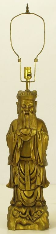 Cast metal and gilt finished table lamp in the image of the famed Chinese philosopher Confucius.  An obvious James Mont and Tony Duquette influence. Sold sans shade.