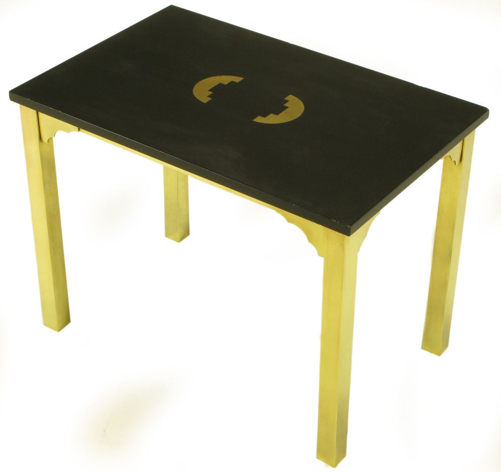 Heavy brass square stock legs with corner brackets and black granite top with inlaid brass geometric pattern.