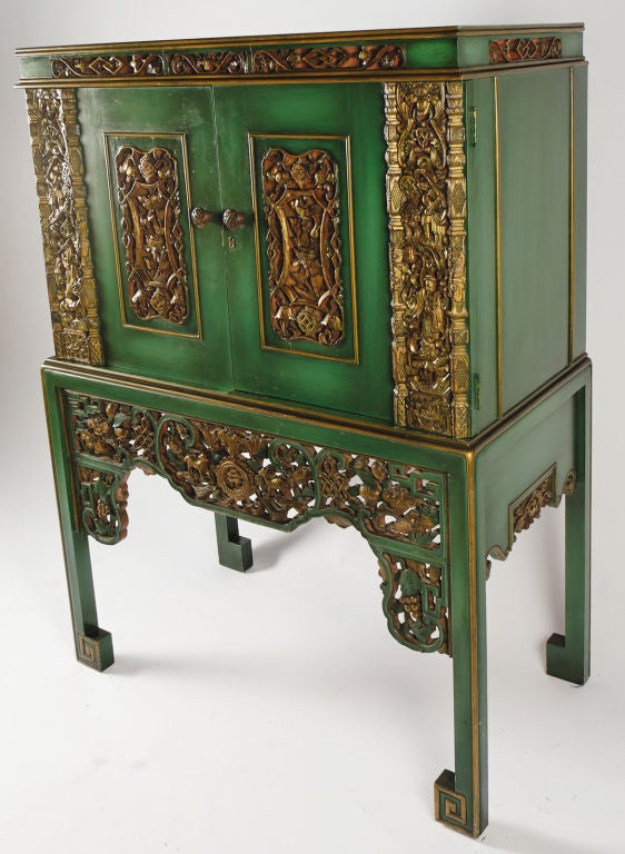 According to the original owner's family, this cabinet was constructed in the 1950s. Nineteenth century carved gilt panels were incorporated into the design, a la James Mont. <br />
<br />
Finished in a vivid green with gilt accents, this striking