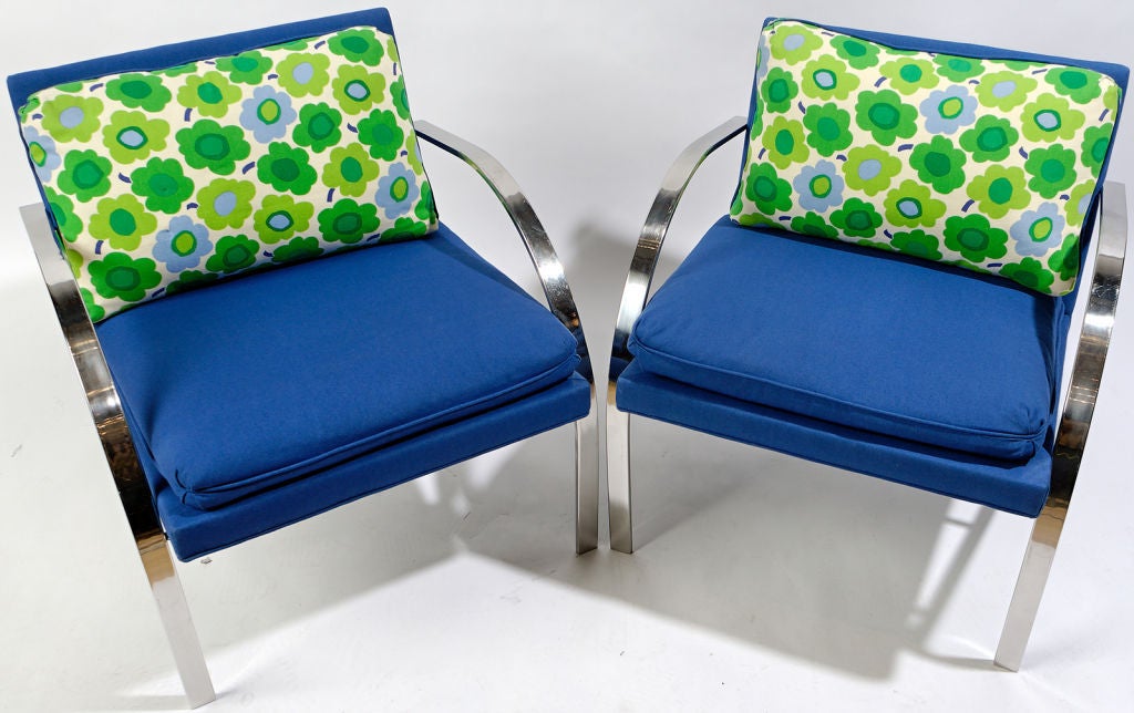 Terrific and colorful pair of Arco chairs by Paul Tuttle. Upholstered in a vintage royal blue wool blend, with back pillows of brightly colored Marimekko floral fabric of white, blues, and greens.