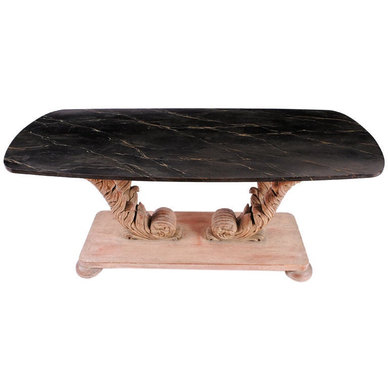Originally commissioned for a lakefront estate in Highland Park, Illinois, this table is similar in design to those of Grosfeld House or Dorothy Draper. 

Four large carved plumes are set upon a platform supported by carved bun feet. Surmounting