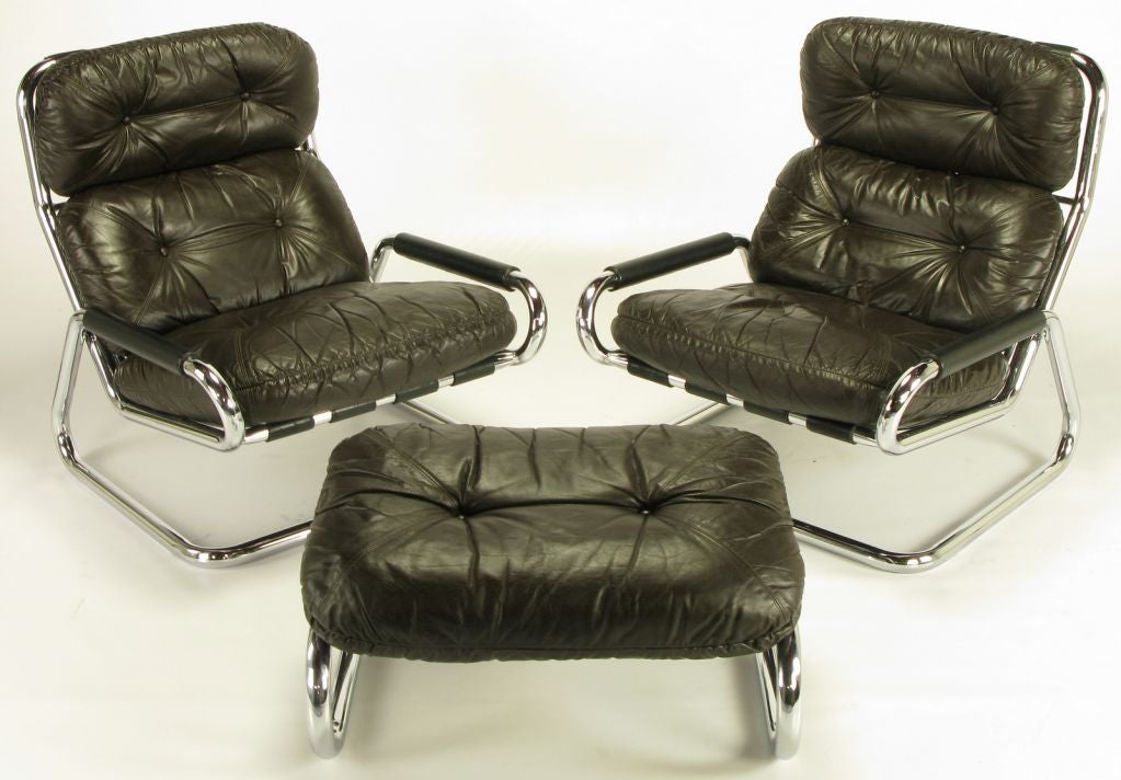 Pair of tubular chromed steel and dark chocolate leather cantilevered lounge chairs by Directional, possibly a Kipp Stewart or Milo Baughman design. Included in the set is a single cantilevered ottoman. Rubberized banding on arms for comfort, <br