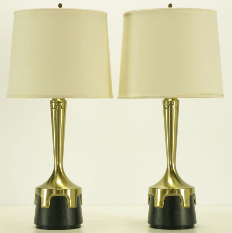 Pair of early Frederick Cooper aged nickel (not brass) and ebonized walnut table lamps. Nickel plated bodies with inverted crenellations clasping ebonized veneer bases. Incised decoration encircling the necks echoes the crenelated design.  Double