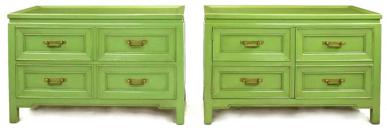 Pair of pistachio green glazed low cabinets by Hekman. One cabinet features two drawer sections and the other a pair of doors that open to reveal partitioned storage. Brass pulls are patinated with escutcheons and drop U form pull. Slight color