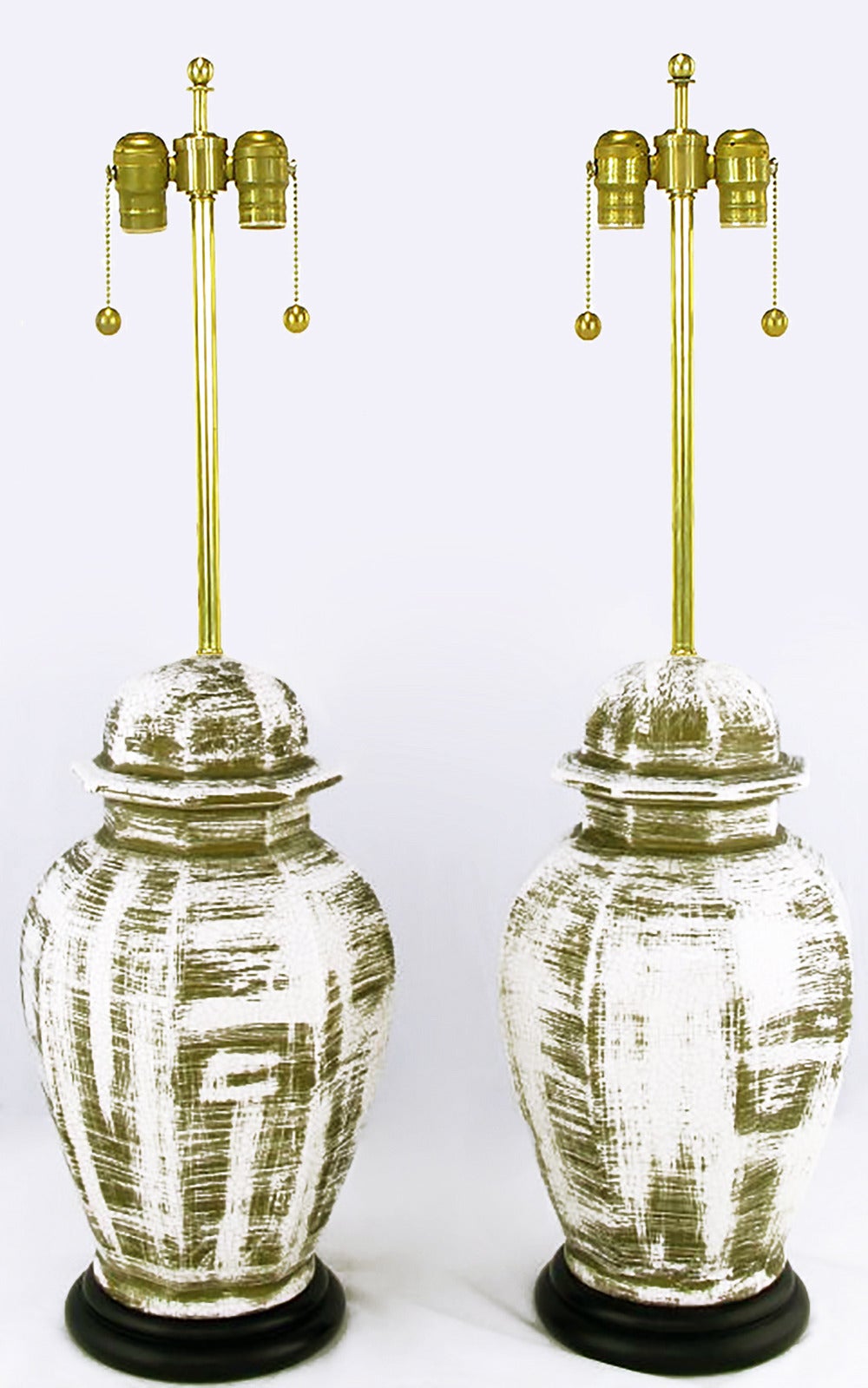 Elegant pair of ginger jar form ceramic table lamps with an aged deep gilt glazing over white crackled porcelain and black lacquered base. New brass stems and double socket clusters. Sold sans shades.