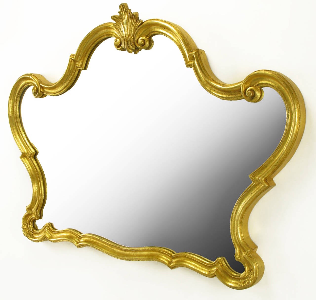 Italian mirror consisting of wood, composite wood and gesso. Finished in gold leaf. Handmade by Florentia. Would make a striking vanity mirror or overmantel mirror.