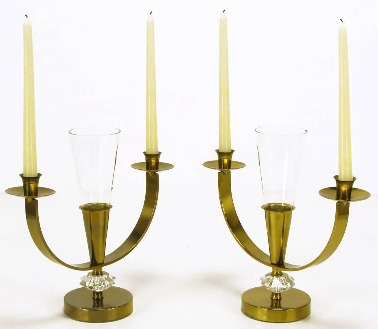 Pair of patinated brass double arm candelabra with cut crystal spacers and leaded crystal fluted center petite vase. Bobeche and striated candle cups are similar to Tommi Parzinger designs for Dorlyn.