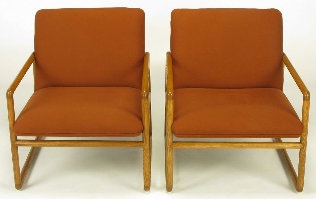Pair of Ward Bennett for Brickel Associates ash wood, open framed sled base lounge chairs. Slightly raked backs and slanted seats are juxtaposed with squared side frames with angled seat supports. Unexpected absent seat back stretcher is found six