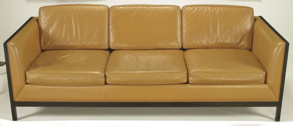 Stow Davis of Grand Rapids Michigan, even arm three seat sofa in camel leather with ebonized ash wood framing and aluminum inlaid detail. Loose seat and back cushions. We also have the matching club chairs available.