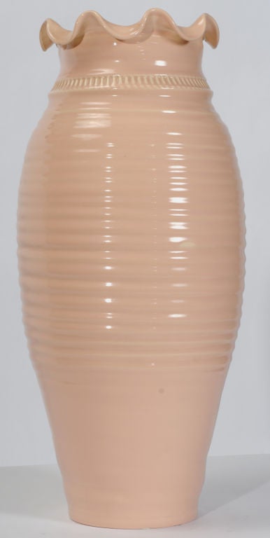 An eighth-generation potter from Italy, Maglio was master potter for Haeger Potteries from 1963 until 1995. From time to time, he would create original hand thrown designs for Haeger, as is the case with this pink glazed vase.