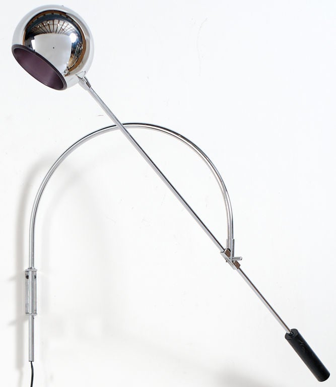 Perfect for bed or chair side reading, this wall lamp has a chrome globe shade that is counterbalanced.