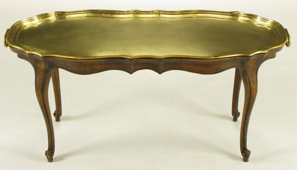 An early 1970s reproduction table by legendary mid-century interior designer and antiquarian, Yale Burge. The walnut base was made in Burge's own New York workshop, and the removable brass tray was made in Germany.