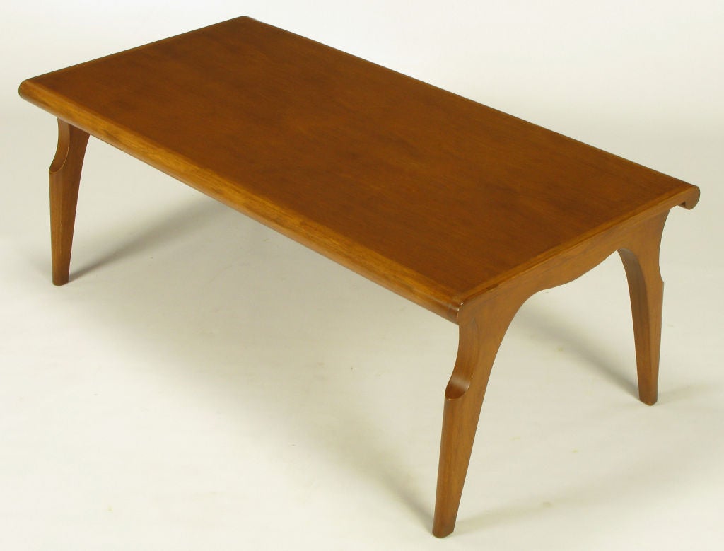 Rare and exquisite sculptural tawny walnut coffee table by John Van Koert for Drexel. Part of the 