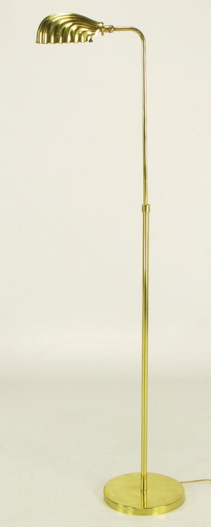 Brass floor/reading lamp with formed brass shell form shade. Incandescent lighting element, and 100 possible watts of illumination.