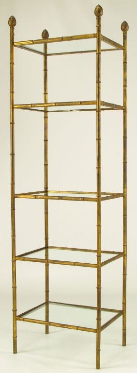 Aged gilt metal etagere in faux bamboo designed legs and shelf supports. Glass shelves are 15