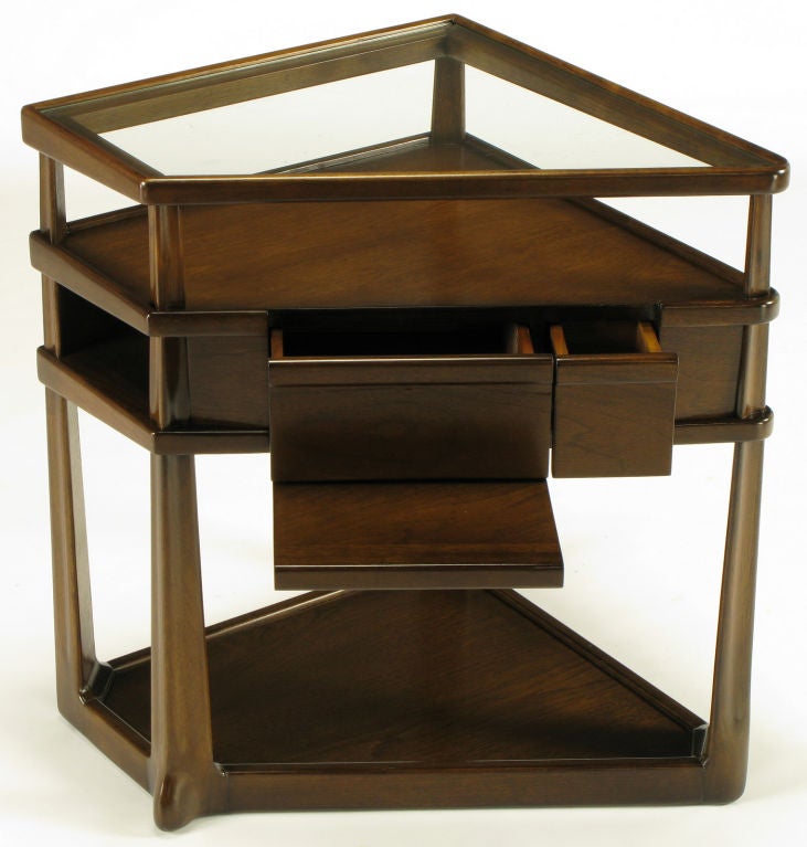 Dark oak hand carved trapezoidal three tired end table by Harold M. Schwartz for Romweber. Three surface levels, with the top being glass. Tapered hand carved legs are inverted triangular shaped.  Run from base to top through the various tiers.