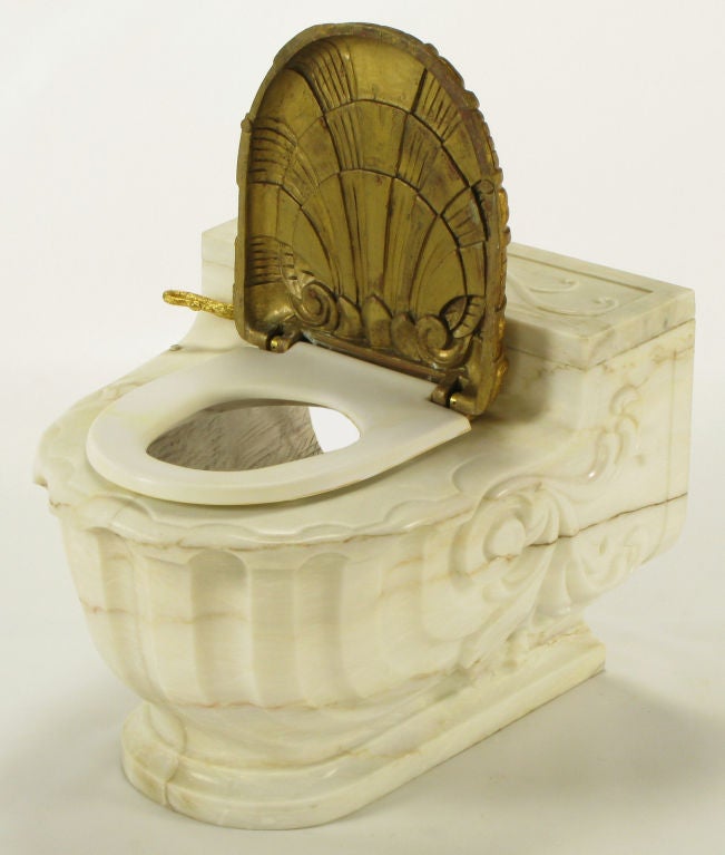 Vintage carved Carrera marble shell shaped water closet with gold plated resin shell seat cover.  Gold plated bronze swan lever. The marble cover fits over and is sold with the custom Briggs low profile commode.