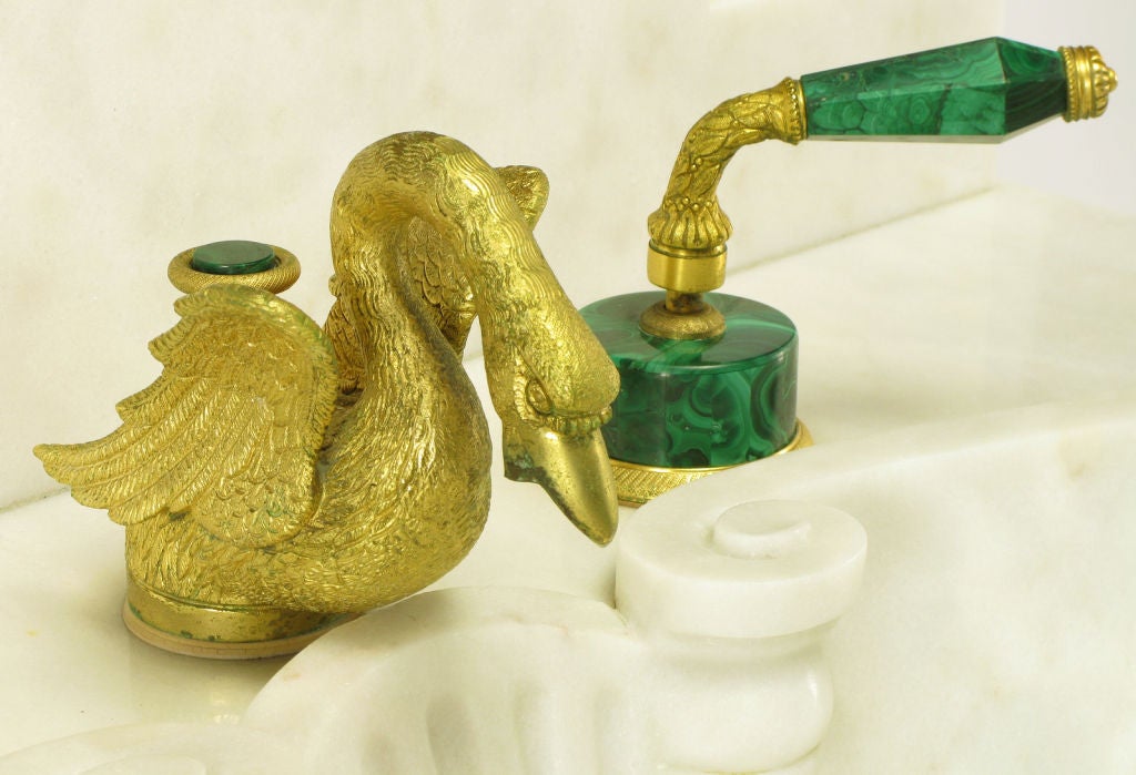 Vintage Sherle Wagner solid malachite and gold plated bronze bathroom sink fittings. Set consists of a pair of malachite and gold plated handles with a gold plated cast bronze swan faucet head with gold plated bronze and malachite medallion pull