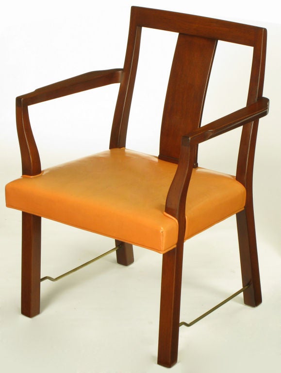 Set of eight mahogany wood and apricot leather curved panel back dining chairs by Edward Wormley for Dunbar.  Set is comprised of two arm chairs and six side chairs. Rarely seen collection with brass rod stretchers.<br />
<br />
Arm chair 23.25