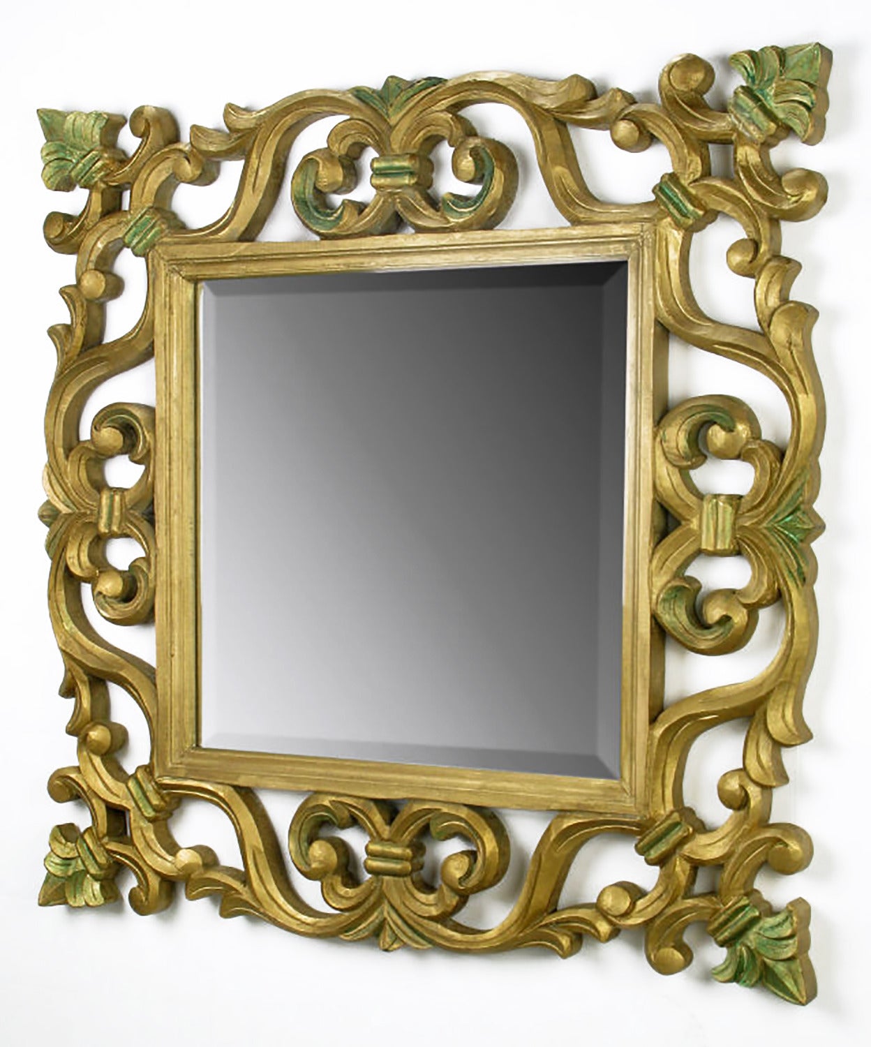 Excellent hand carved and giltwood framed beveled edge mirror with shades of verde accents. Versatile mirror with many applications.