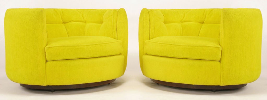 Pair of ovoid shaped barrel chairs with button tufted backs and loose seat cushions. Walnut veneered bases with inset casters.Excellent build quality, originally sold through the John M Smythe Company, one of the only furniture stores to have opened