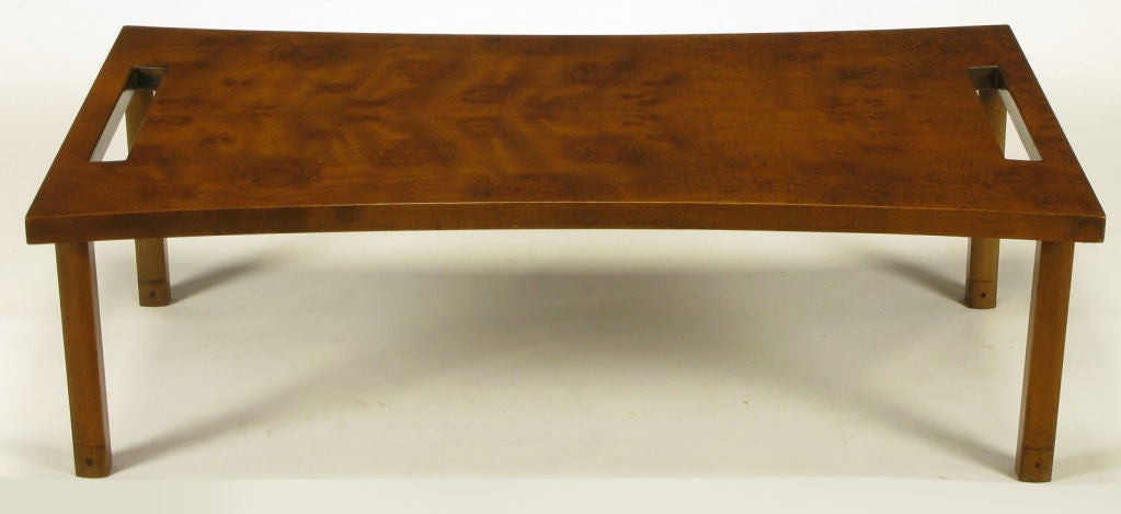 Convex-curve edge burled walnut coffee table, by Harold M. Schwartz for Romweber. Carved openings at each end resemble a tray top.