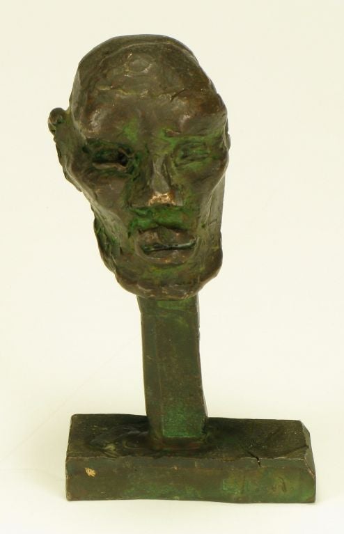 Cast bronze abstract head mounted on cut bronze stem and base. Signed E.P. Anderson.