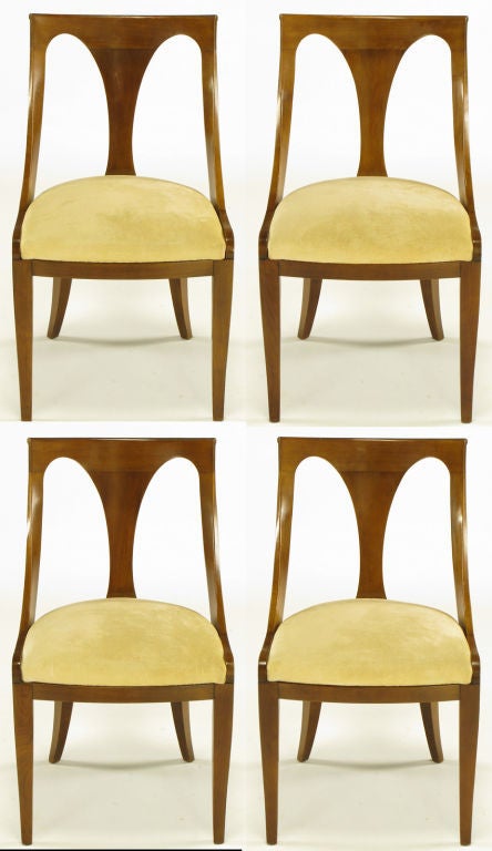 Set of four walnut and cream velvet Italian style scooped back dining chairs with center hour glass curved panel. Uncommon lower curvature detail to the front and back tapered legs
