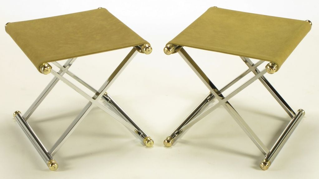 Pair of chrome sled based X-base sling seat stools or benches. Camel simulated suede upholstered seats, brass finial end caps.