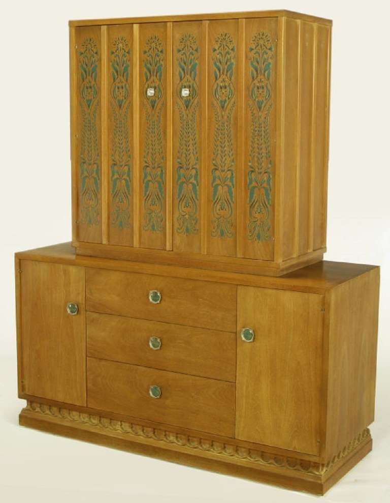 From John Van Koert's Casa del Sol collection for Drexel. Two-piece tall cabinet in bleached walnut, with original hand stenciled green and yellow floral detail on the upper cabinet doors. Pair of upper doors with silver-polished nickel pulls open