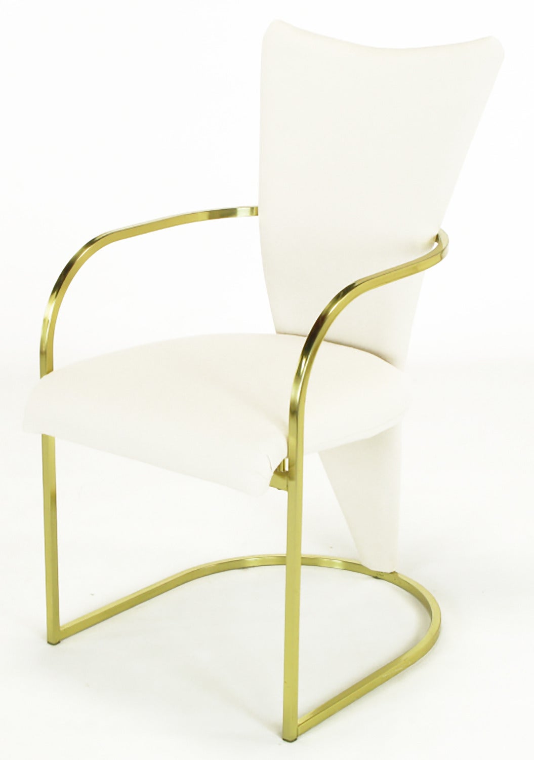 Set of six DIA brass square bar framed dining chairs, in new white wool upholstery, influenced by the designs of the Memphis Group. Rolled front edge seat with triangular shaped back that extends to become the single back leg. Four side chairs and