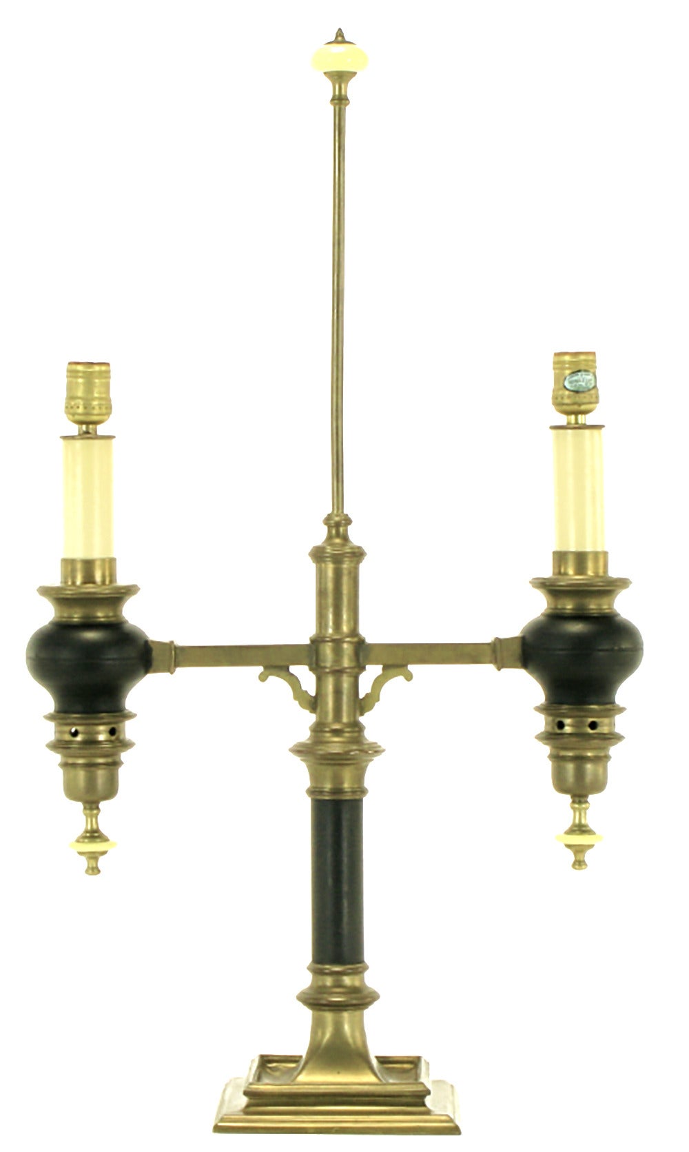 Beautiful natural brass patina and black lacquered Empire style table lamp by Chapman Lighting. Converted gas light style with a pair of vented brass and black lacquered candle bases and cross shaped brass fitters. Brass and bakelite lower and upper